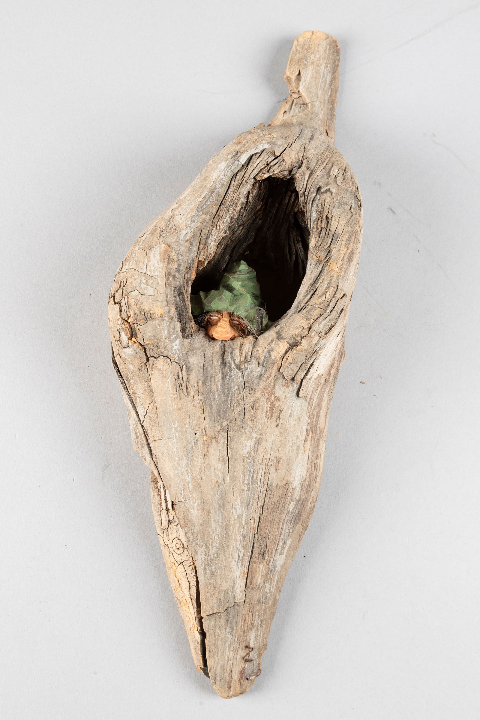 Signed wooden hand carved Sculpture by noted Texas Artist Gene Zesch (1932), dated 3/10/76, no title: Signed wooden hand carved Sculpture by noted Texas Artist Gene Zesch (1932), dated 3/10/76, no title found, depicts a character staring out of a tree knot holding a pistol, measures 13 1/4" L x 4 1/2"