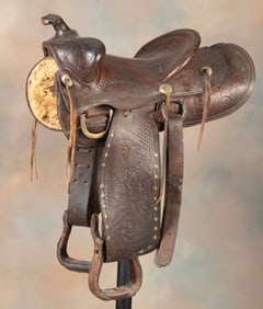 Vintage tooled leather Saddle marked "F. Vela, Floresville, Tex.", border  showing nickel covered