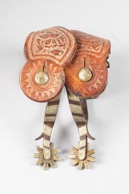 Inside marked "Crockett" single mounted Spurs with chap guards. Sold with a pair of tooled two-piece