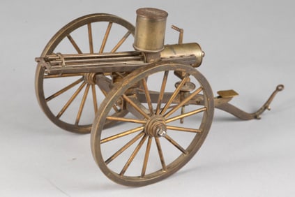 Solid brass miniature Gatling Gun, with 4 1/2" wheels, 6 1/2" overall length. Great detail. Jim