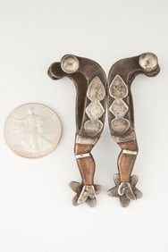Miniature single mounted gal-leg Spurs, marked with the initials "F.T."  Note: Most spur makers will