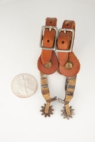 Pair of single mounted miniature Spurs, hand engraved with inside mark "Monty J.C. WYO.", with chap