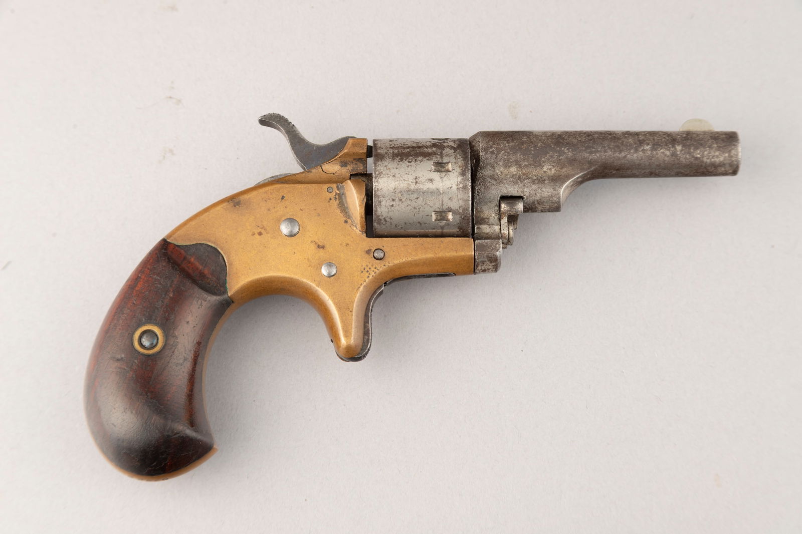 Antique Colt, Open Top, 7-shot Pocket Model Revolver, circa 1871-1877, brass frame with bird beak: Antique Colt, Open Top, 7-shot Pocket Model Revolver, circa 1871-1877, brass frame with bird beak grip, .22 Short /LR caliber, SN 65239, 2 3/8" barrel. Mechanically sound. Finish shows aged gray to br