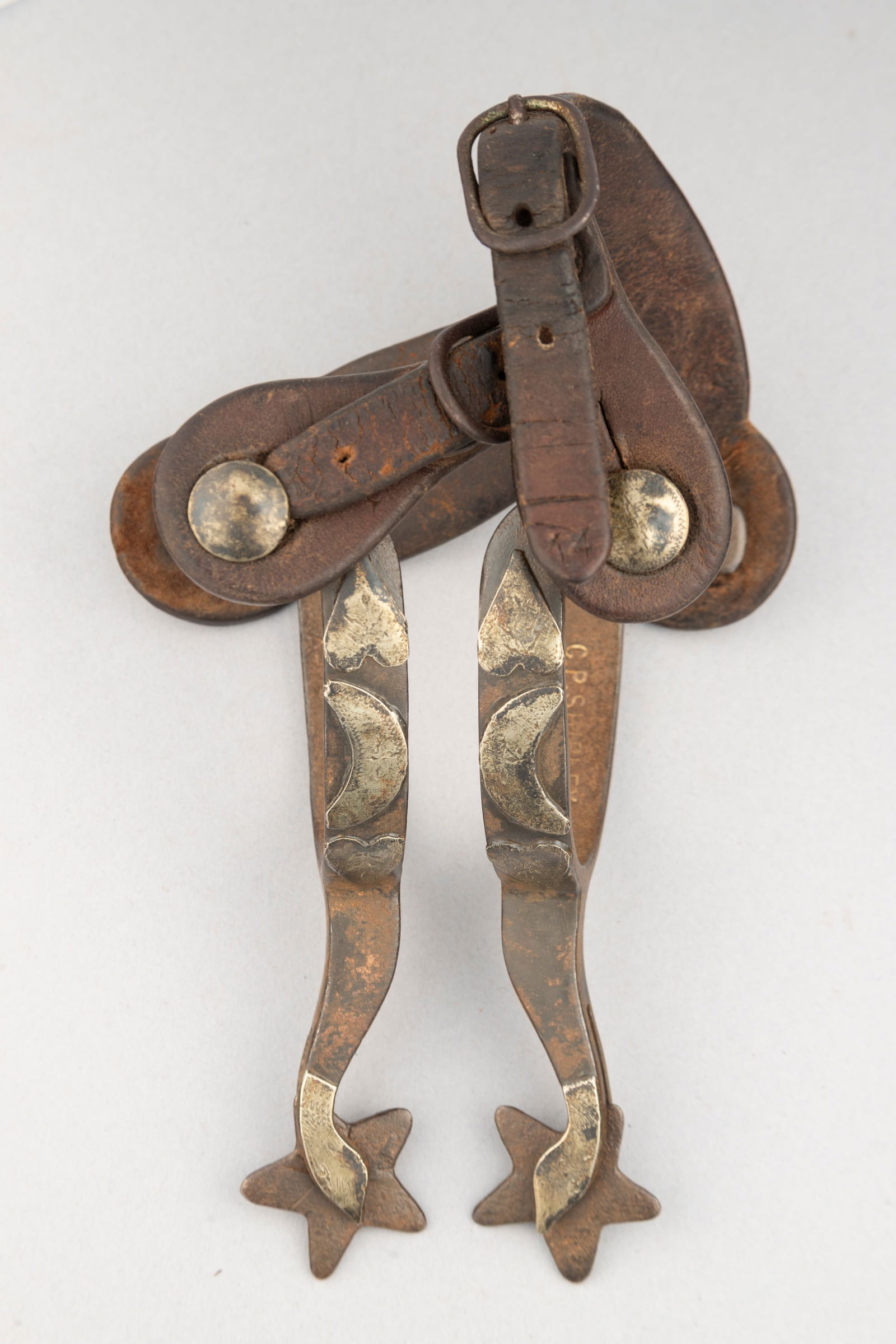 Pair of "C.P. Shipley, Kan. City, Mo." marked single mounted Spurs with hearts, crescent & goose: Pair of "C.P. Shipley, Kan. City, Mo." marked single mounted Spurs with hearts, crescent & goose head shanks. Sold with a pair of "H&B" marked two-piece vintage straps. Maples Estate.