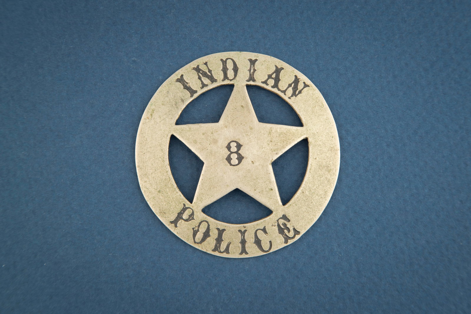 Large Circle 5-point Star Badge marked “INDIAN/ POLICE?? with “8?? in center of Star, in: Large Circle 5-point Star Badge marked “INDIAN/ POLICE” with “8” in center of Star, in circus lettering. Hallmark on back, on the saddle pin and catch, is unreadable and measures 2 &fr