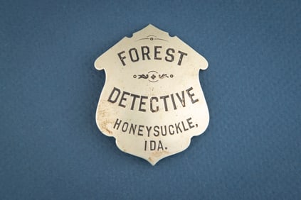 Large unusual shaped vintage Shield Badge marked “FOREST/ DETECTIVE/ HONEYSUCKLE, /IDA.??.