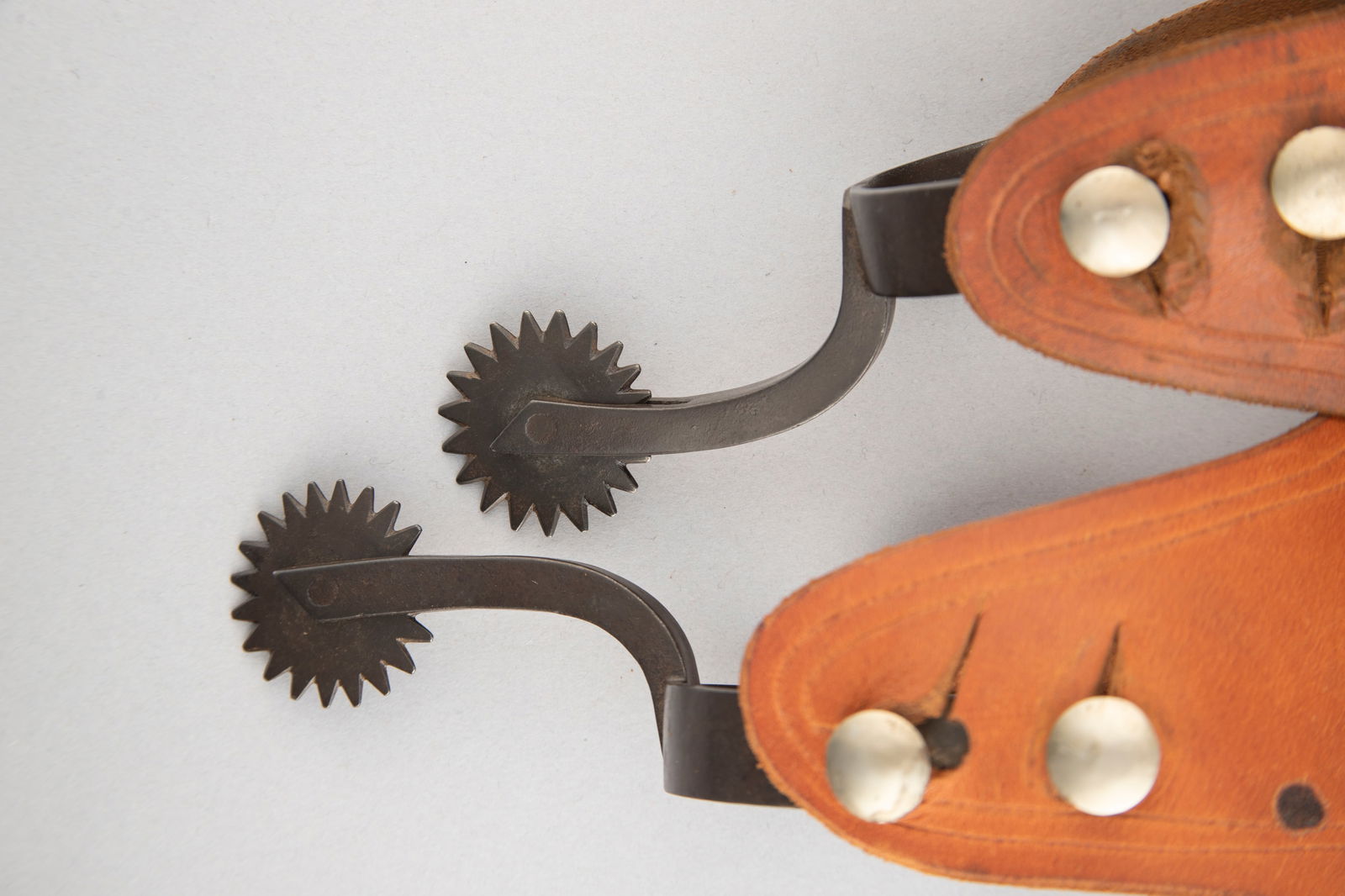 Pair of plain iron Spurs with double buttons, attributed to Rex Schnitger, 1877-1947, Cheyenne, Wyo.: Pair of plain iron Spurs with double buttons, attributed to Rex Schnitger, 1877-1947, Cheyenne, Wyo. In the 1920s he went to work for Edward H. Bohlin. Spurs are mounted with a pair of plain two-piece