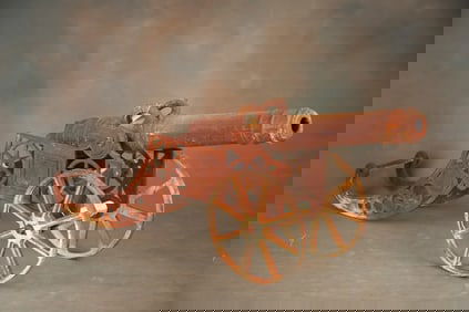 Heavy cast iron Cannon on iron carriage, 15 1/2" iron wheels, 40 1/2" long barrel with 1 3/4" bore.