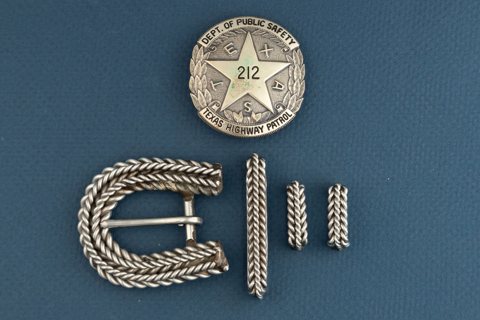 Silver Shield Type Badge with 5-point star marked " Dept. of Public Safety/ 212/ Texas Highway: Silver Shield Type Badge with 5-point star marked " Dept. of Public Safety/ 212/ Texas Highway Patrol" with TEXAS spelled out between star points. measures 1 7/8" L x 1 3/4" W. Badge is sold with a fo