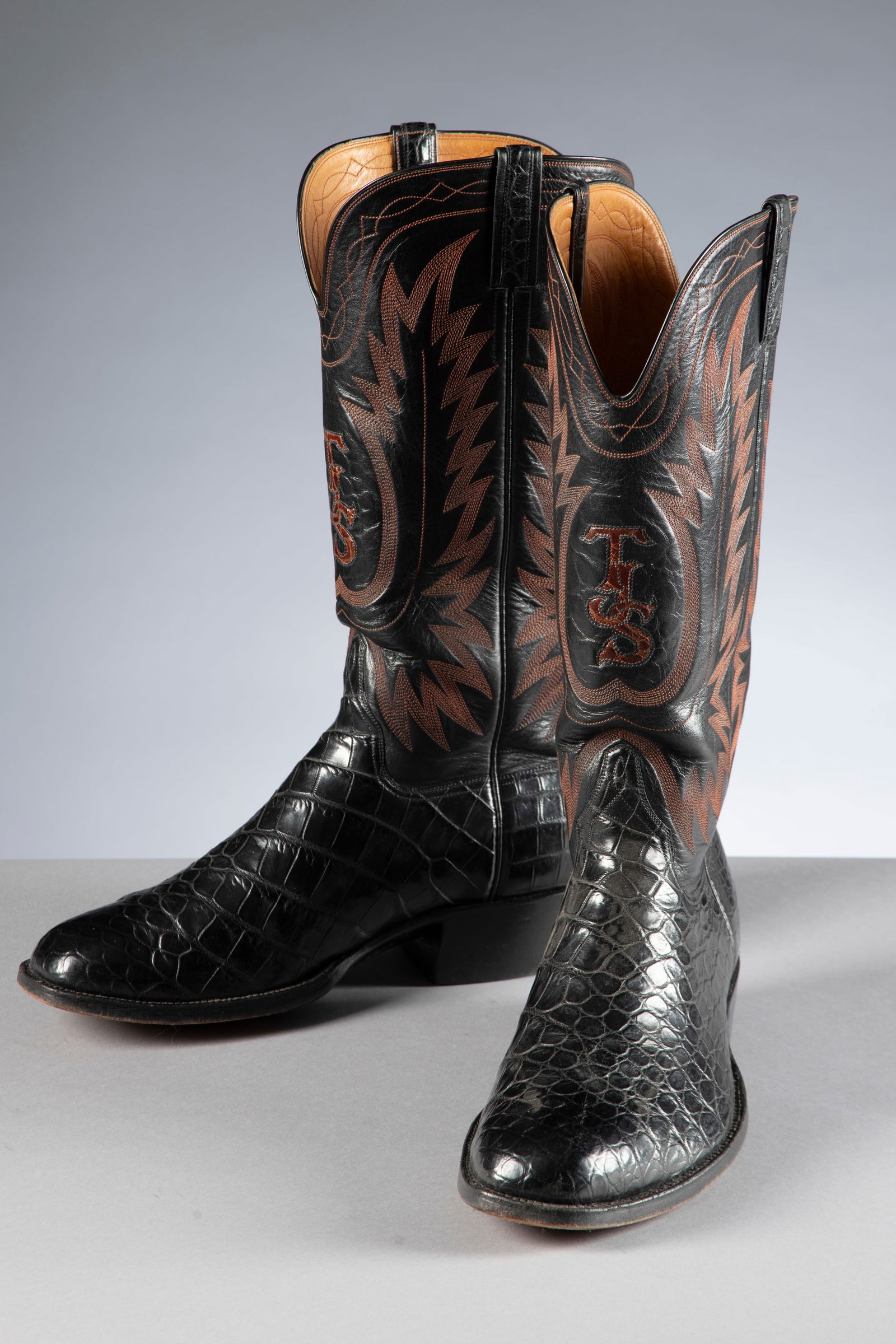 A fine pair of alligator western Dress Boots with red stitched tops, size 10, 12" tops, show very: A fine pair of alligator western Dress Boots with red stitched tops, size 10, 12" tops, show very little wear. Marked inside "Texas Tradition/Hand Made/Austin, Texas".