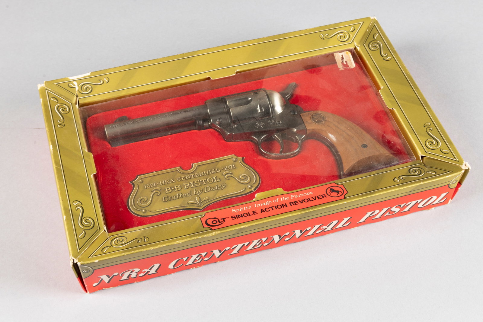 Daisy, 1871-1971, NRA Centennial Pistol, Single Action BB Gun, .177 caliber, in its original box, 4: Daisy, 1871-1971, NRA Centennial Pistol, Single Action BB Gun, .177 caliber, in its original box, 4 3/4" barrel, believed to be in unused condition. Box is complete but is somewhat fragile. Paul Chapm