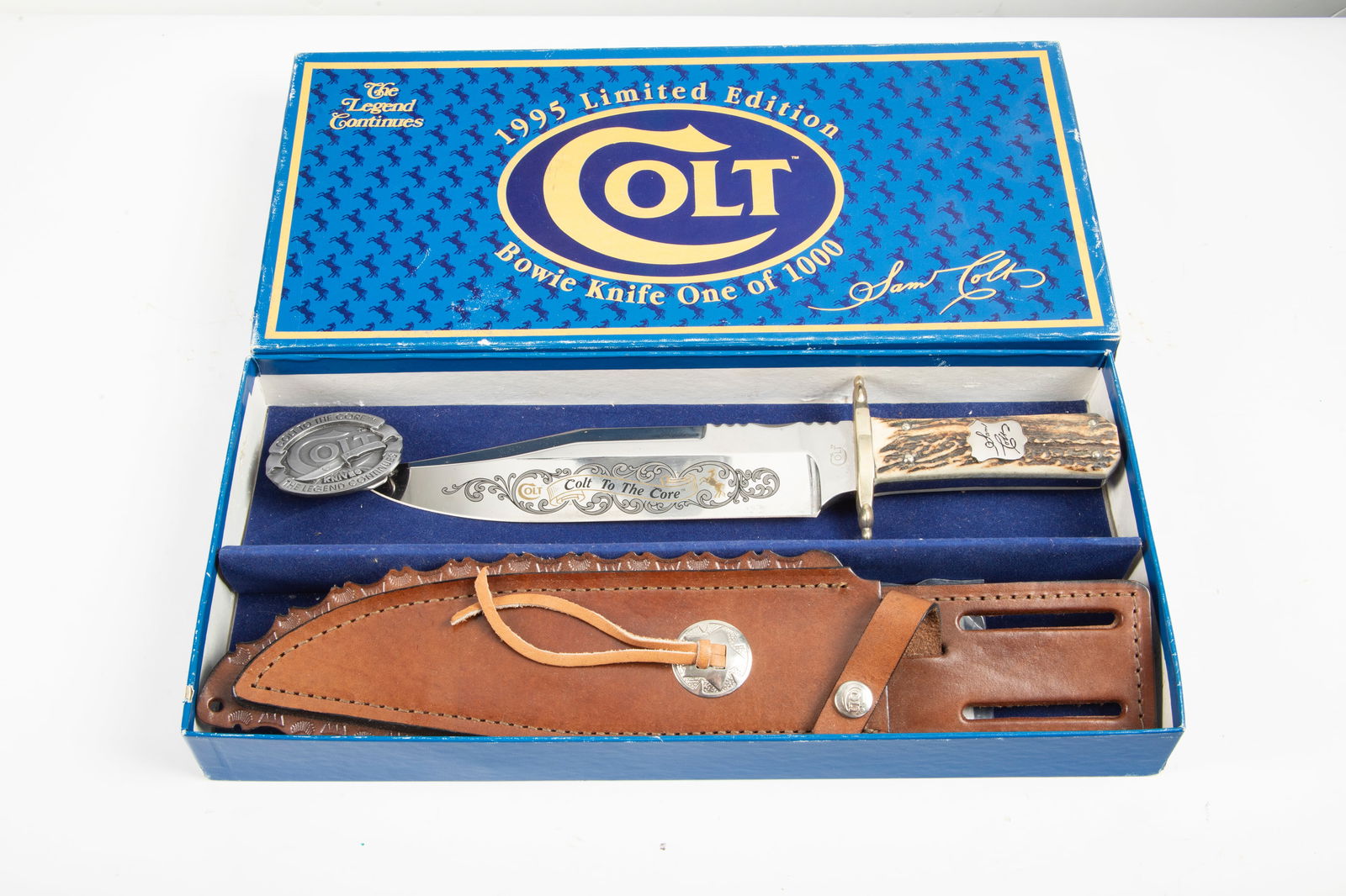 "Colt" marked Clip Point Bowie Knife in original picture box. Marked on blade "Colt to the Core".: "Colt" marked Clip Point Bowie Knife in original picture box. Marked on blade "Colt to the Core". Sold in original box with matching leather sheath and belt buckle. Extremely fine quality with 9 1/4"