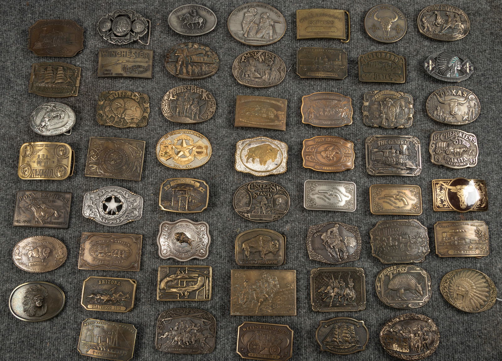 Huge collection of embossed brass Belt Buckles totaling 54, ranging in size of 3"- 4" across. All: Huge collection of embossed brass Belt Buckles totaling 54, ranging in size of 3"- 4" across. All are very collectible, some have Indian Heads, Steer Heads, Buffalo, Well Fargo, Pony Express and many