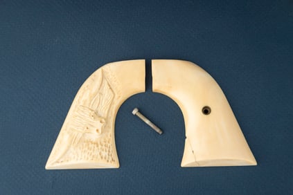 Pair of Steer Head carved Ivory Grips for a SAA Revolver. Right hand grip shows a faint hairline