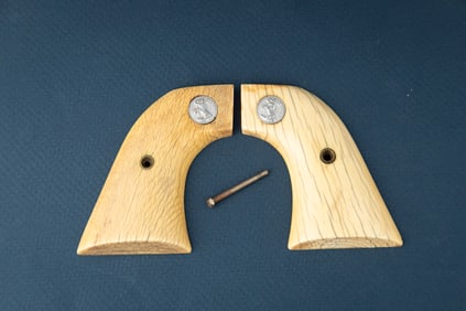 Pair of two-piece Ivory Grips for a Colt SAA Revolver. Grips have inlaid Colt Medallions.