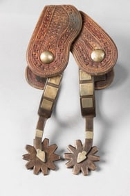 "McChesney" marked single mounted Spurs, #104-2, with arrow shanks and etched fixed buttons. Mounted