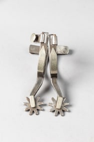 Pair of "Kelly Bros." marked single mounted Spurs, #56, with etched swing buttons. Maples Estate.