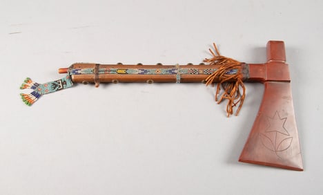Carved clay Pipe Axe with 7 3/4" axe head, 11 1/4" wooden stem and beadwork. Dr. Ed Kollar Estate.