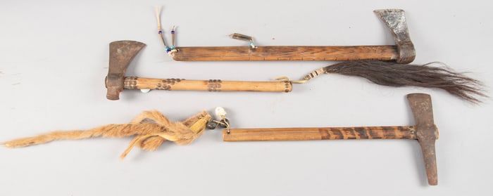 This lot consists of three early Axes. One with a 7" iron axe head, 14" wooden handle decorated with