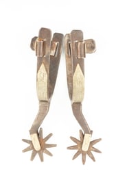 Pair of "Kelly Bros." marked single mounted Spurs, #56, with etched swing buttons. Maples Estate