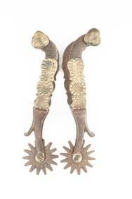 Pair of McChesney single mounted Spurs, #3, with chap guards and etched silver heart buttons. Maples