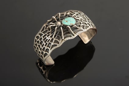 This lot consists of two Sterling and Turquoise Cuffs, one has a spider on web with turquoise back.