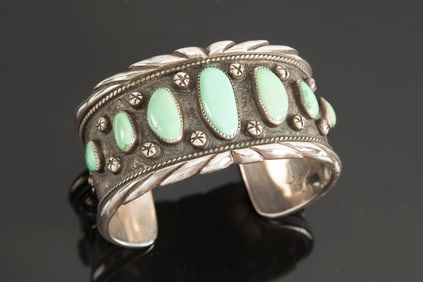 Lovely "Sterling" marked Cuff with seven graduated turquoise stones.