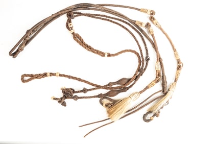 Two pairs of vintage Reins. One pair is braided rawhide with horse hair tassel and 14" popper. The