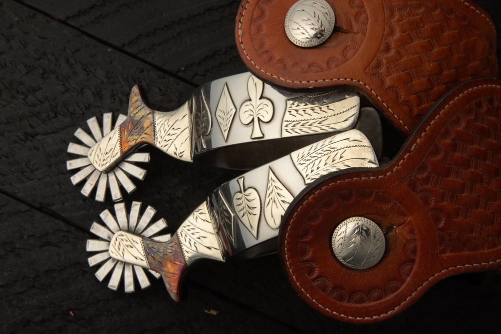 Pair of Wayne Dollar "$" marked double mounted Spurs in the card suit pattern, engraved copper chap (1 of 2)
