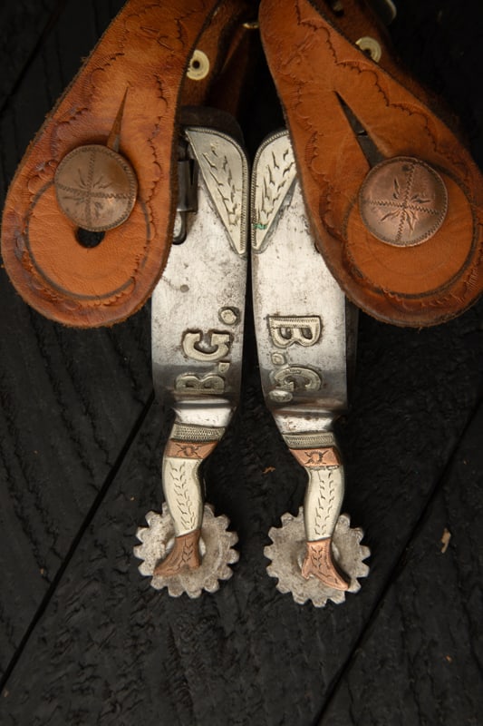 Pair of "Jerry Cates" marked single mounted gal-leg Spurs marked with the early "OX" mark with: Pair of "Jerry Cates" marked single mounted gal-leg Spurs marked with the early "OX" mark with raised silver overlay engraved letters "B.G.". Mounted with vintage two-piece straps. Straps are mounted