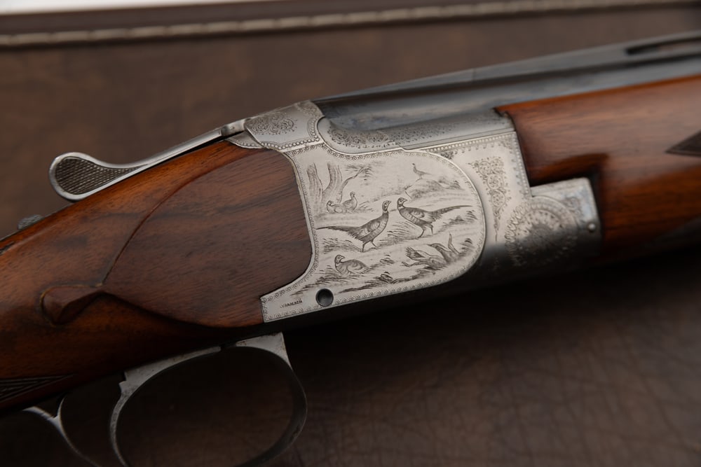 Fabrique Nationale O/U Superposed B2 Grade, 20 ga., Shotgun, SN 17328, 28" barrels, choked full: Fabrique Nationale O/U Superposed B2 Grade, 20 ga., Shotgun, SN 17328, 28" barrels, choked full /mod, length of pull 14 1/4", engraving signed by Louis Vrancaen, in fitted case. Good condition. Estima