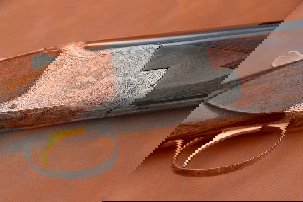 Belgium Browning O/U 12 ga. Shotgun, SN 14673 S69, engraved receiver with quail, rabbits and ducks: Belgium Browning O/U 12 ga. Shotgun, SN 14673 S69, engraved receiver with quail, rabbits and ducks by Master Engraver M. Debrus, gold trigger, blue finish, 26 1/2" ribbed barrel. Light scratching on f