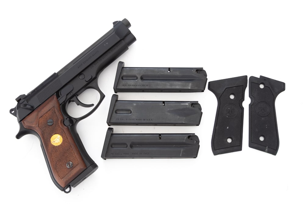 Beretta, Model M9, Semi-Auto Pistol, 9 MM caliber, SN M9-4368, matte finish, 5" barrel, checkered: Beretta, Model M9, Semi-Auto Pistol, 9 MM caliber, SN M9-4368, matte finish, 5" barrel, checkered walnut grips, shows to be a Special Edition. Sold in its original glass front display case. Pristine c