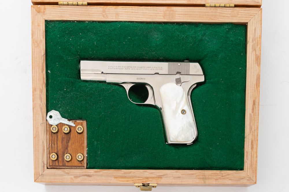 Colt, Model 1908, Semi-Auto Pistol, .380 caliber, SN 82755, fine original nickel finish, 4" barrel,: Colt, Model 1908, Semi-Auto Pistol, .380 caliber, SN 82755, fine original nickel finish, 4" barrel, pearl grips. Sold in fitted wooden and glass display case with wooden ammo block. (MODERN) Estate of