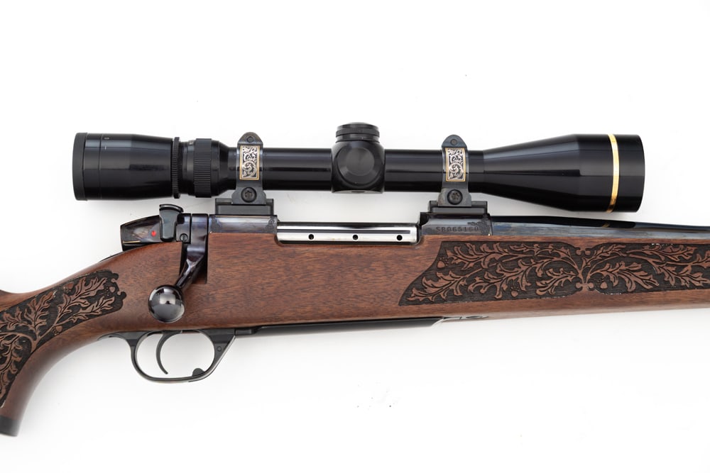 Weatherby, Mark V custom, .340 Weatherby Mag caliber, BA Rifle, SN SB065160. Stunning custom shop: Weatherby, Mark V custom, .340 Weatherby Mag caliber, BA Rifle, SN SB065160. Stunning custom shop Rifle with engraved and gold inlaid receiver, laser carved stock, 26" threaded barrel, fitted with Leu