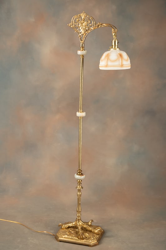 Antique, fully restored Goose Neck Bridge Lamp with solid brass turkey foot base. Embossed brass: Antique, fully restored Goose Neck Bridge Lamp with solid brass turkey foot base. Embossed brass stem with onyx spacers, original 7 1/2" Dia. embossed cream color shade, measures 58" T with heavy weig