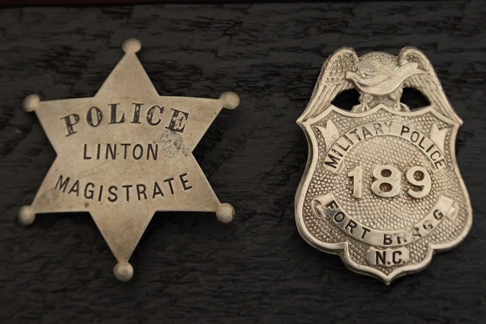 This lot consists of two Badges to include: (1) Vintage Shield shaped Badge with Eagle Crest top (1 of 2)