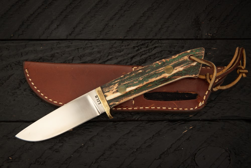 Handmade Knife by Jimmy Lile past president of The Knifemakers Guild, Model Big Seven with stag: Handmade Knife by Jimmy Lile past president of The Knifemakers Guild, Model Big Seven with stag grips, blade is 3 3/4", overall length is 8 3/4", sold in its original leather sheath with paper work.