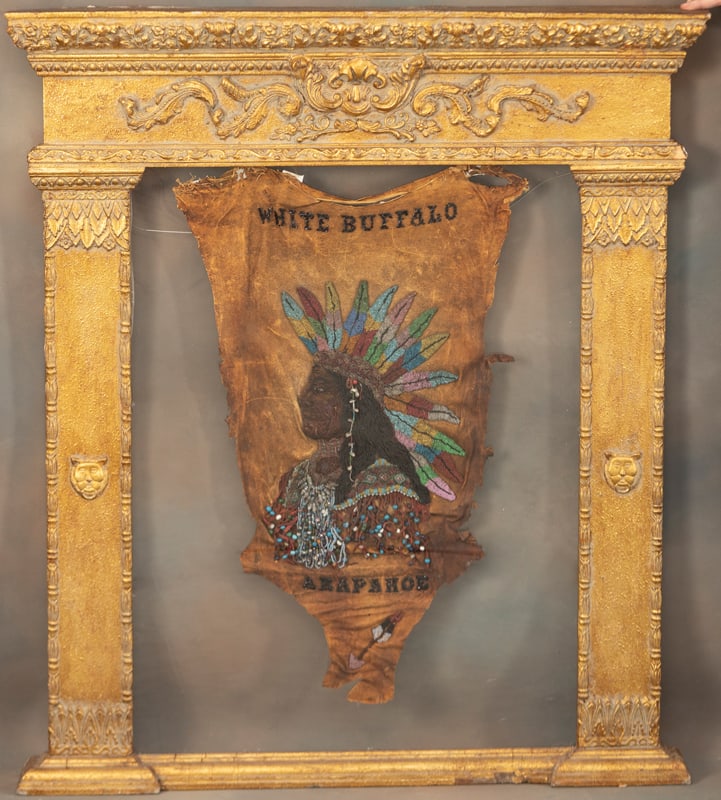 Rare antique Wild West Beaded and Leather Banner, marked in beads "White Buffalo Arapahoe",: Rare antique Wild West Beaded and Leather Banner, marked in beads "White Buffalo Arapahoe", depicting beaded Indian Chief with headdress, in gold gilt wooden frame. Actual Banner measures 3 ft. L x 23