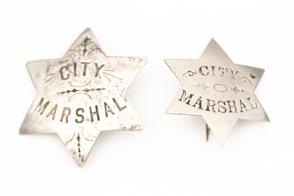 This lot consists of Two (2) Badges to include: (1)Vintage silver tone 6-point Star Badge marked (1 of 2)