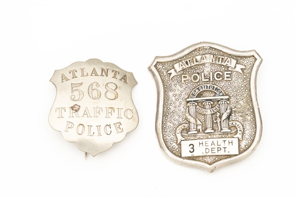 This lot consists of Two (2) Badges to include: (1) Small vintage silver tone Shield Badge marked (1 of 2)