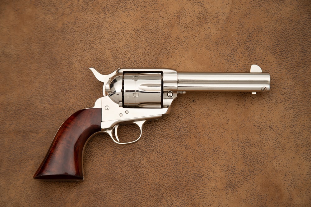 Uberti SA Revolver, .45 caliber, SN 95840, nickel finish, 4 3/4" barrel, one piece wooden grips with: Uberti SA Revolver, .45 caliber, SN 95840, nickel finish, 4 3/4" barrel, one piece wooden grips with high finish, in excellent condition. Sold with single loop tooled Holster and Belt Rig, belt has br