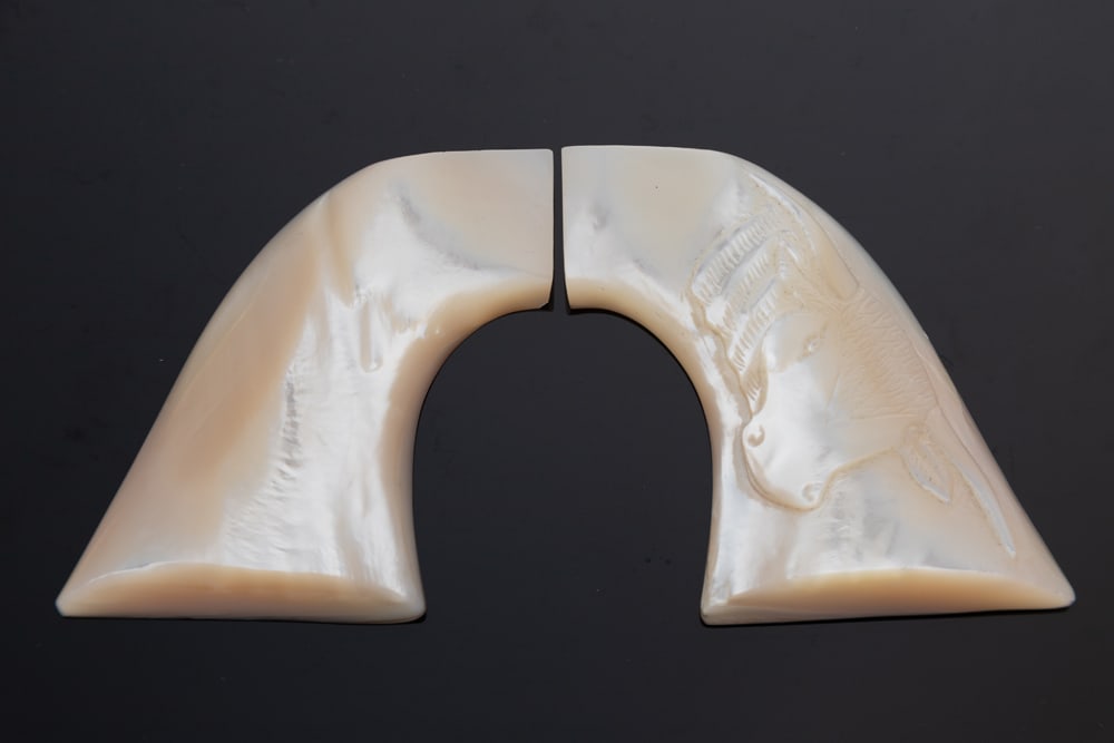 Pair of beautiful carved one-piece Pearl Grips, with carved Horse Head on left grip, excellent: Pair of beautiful carved one-piece Pearl Grips, with carved Horse Head on left grip, excellent condition. Estate of the late Texas Collector, Dwayne Harper