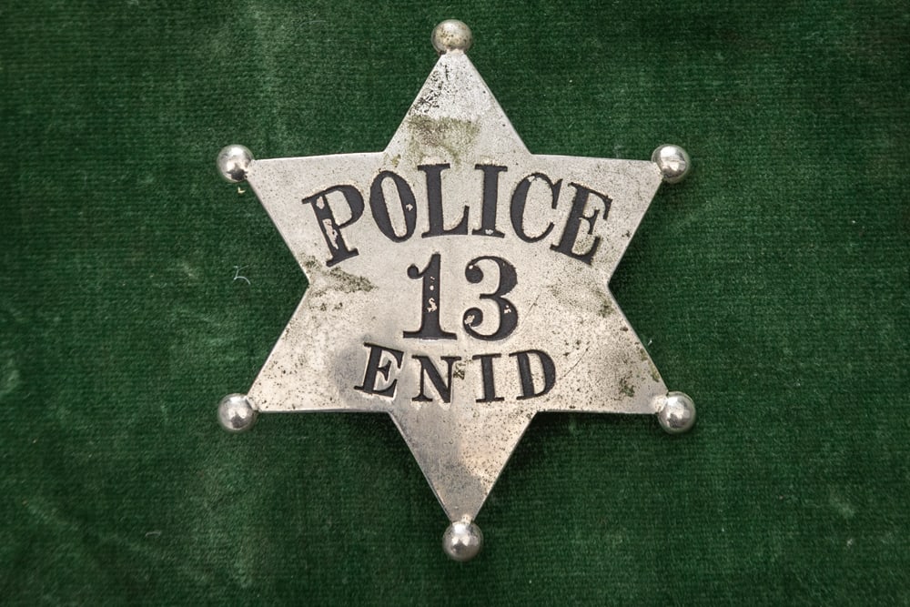 Vintage 6-point Ball Star Badge marked “POLICE / 13 / ENID?? (surely Oklahoma), with filled in: Vintage 6-point Ball Star Badge marked “POLICE / 13 / ENID” (surely Oklahoma), with filled in ball tips, most of the soft black enamel is intact, has large saddle pin and catch, measures 2 5/8
