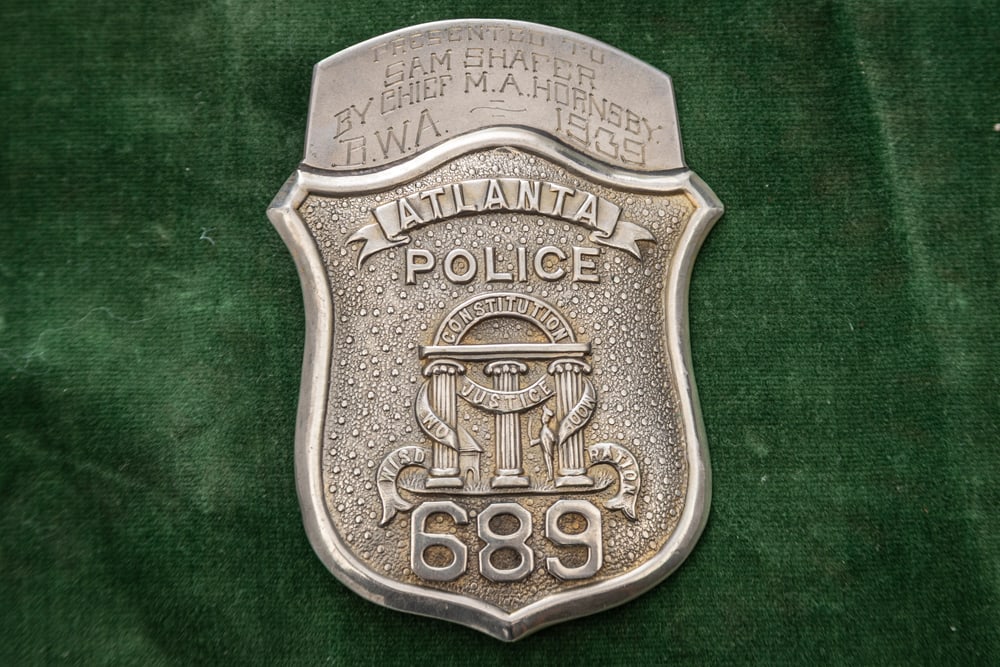 Vintage Shield Badge marked “ATLANTA / POLICE/ 689?? with banner presentation topper that says: Vintage Shield Badge marked “ATLANTA / POLICE/ 689” with banner presentation topper that says “PRESENTED TO/ SAM SHAFER/ BY CHIEF M.A. HORNSBY/ B.W.A. ~ 1939". Nice condition Badge with work