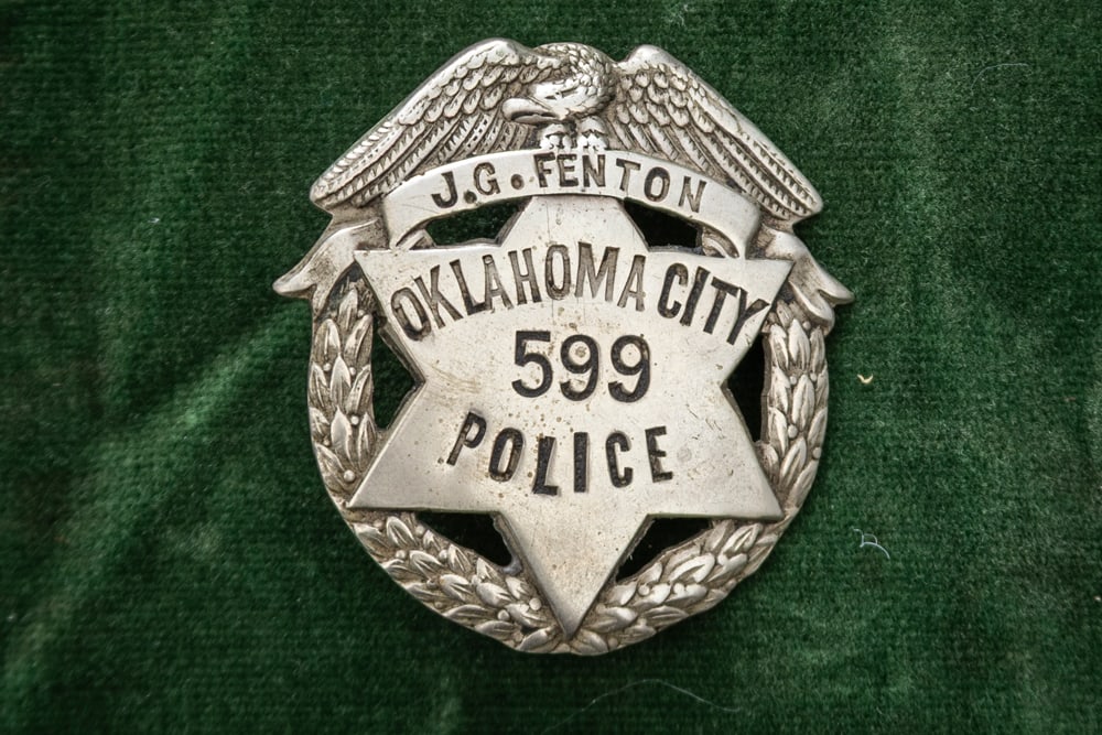 Small vintage Circle Badge with 6-point cut-out Star and winged Eagle Crest marked “J.G. FENTON /: Small vintage Circle Badge with 6-point cut-out Star and winged Eagle Crest marked “J.G. FENTON / OKLAHOMA CITY / 599 POLICE”, with wreath design around Star. Measures 1 5/8” T x 1 &frac