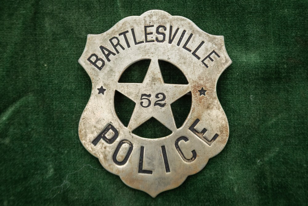 Vintage Shield shaped Badge with cut-out 5-point Star marked “BARTLESVILLE / POLICE?? with: Vintage Shield shaped Badge with cut-out 5-point Star marked “BARTLESVILLE / POLICE” with “52” in center of Star. Great condition with wonderful patina, has small spring pin and catch,