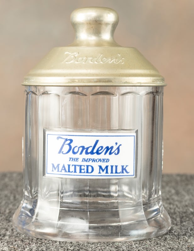 Borden's Glass Advertising Jar, circa 1920's, with heavy porcelain advertising label for Malted: Borden's Glass Advertising Jar, circa 1920's, with heavy porcelain advertising label for Malted Milk, excellent condition, with original embossed "Borden" metal lid, 9 1/2" T x 5 1/2" at base.. Very r
