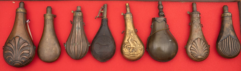 Collection of eight (8) antique brass Powder Flasks sold as a collection that vary in size from 9 (1 of 2)