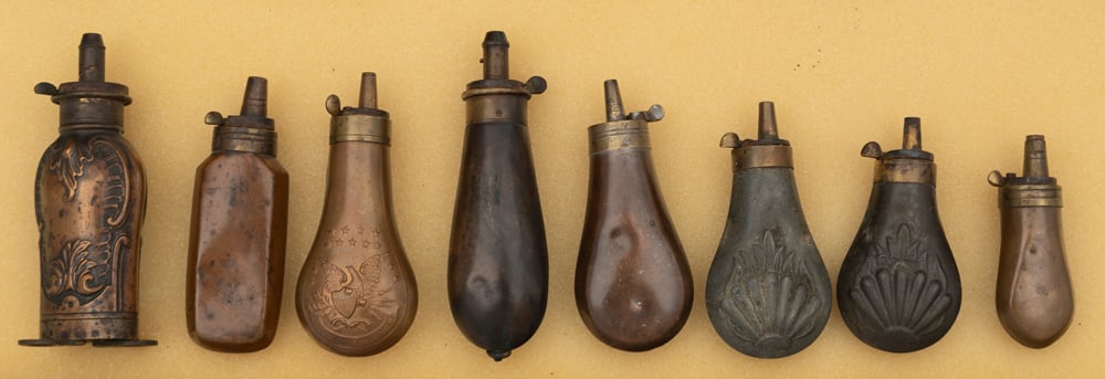 Collection of eight (8) small antique Powder Flasks that vary in size from 5 1/4" to 3 1/2" long. (1 of 2)